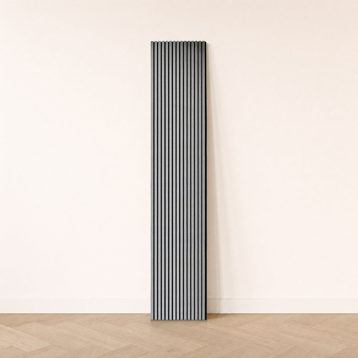 Coastal Gray acoustic slat panel, full height, leaning against an off-white wall on a light herringbone oak floor